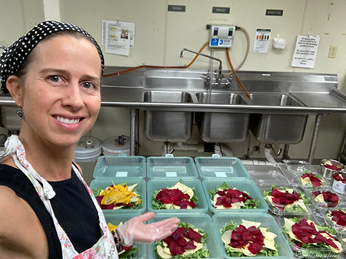 Abundance Cafe owner using the reusable containers